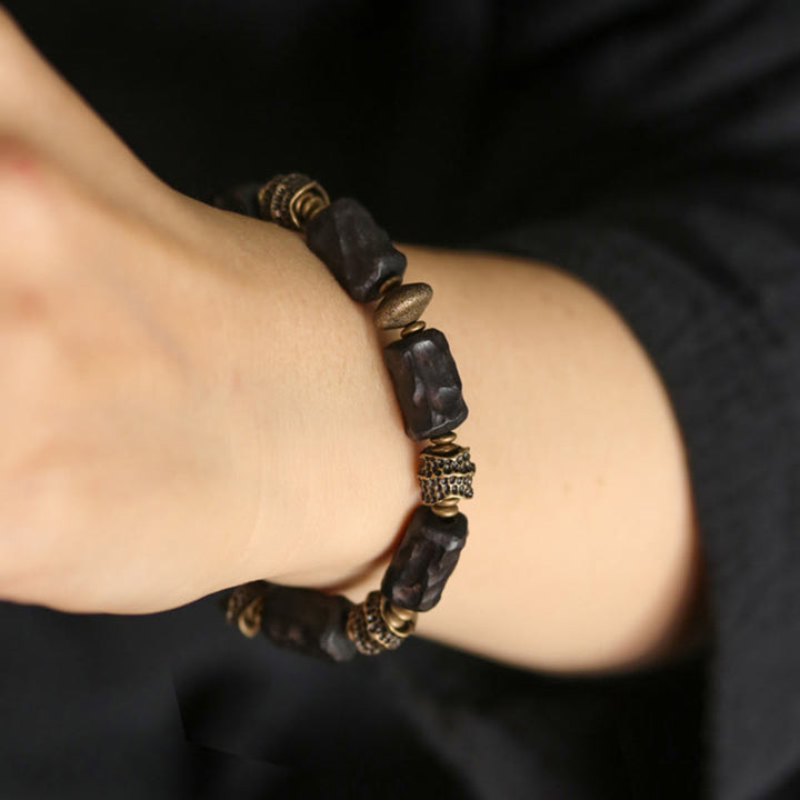 Bracelet tibétain en bois d'ébène et cuivre avec Buddha Stones pour la paix et le calme