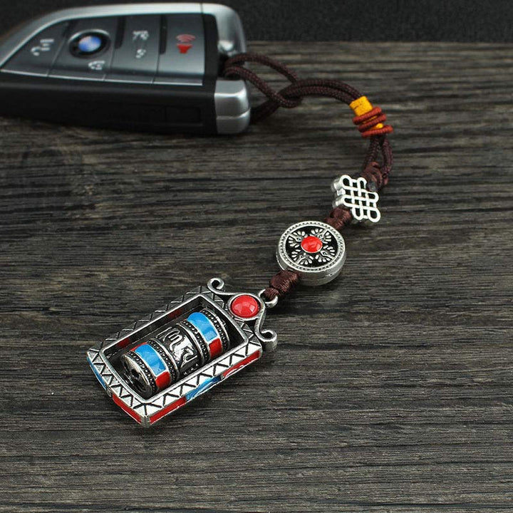 Porte-clés décoratif avec nœud rotatif et bénédiction en forme de roue de prière en six mots vrais en Buddha Stones