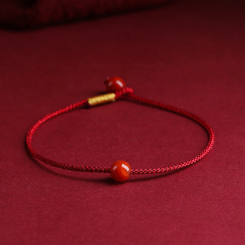 Bracelet en fil rouge avec bénédiction en agate rouge cinabre naturelle de Buddha Stones