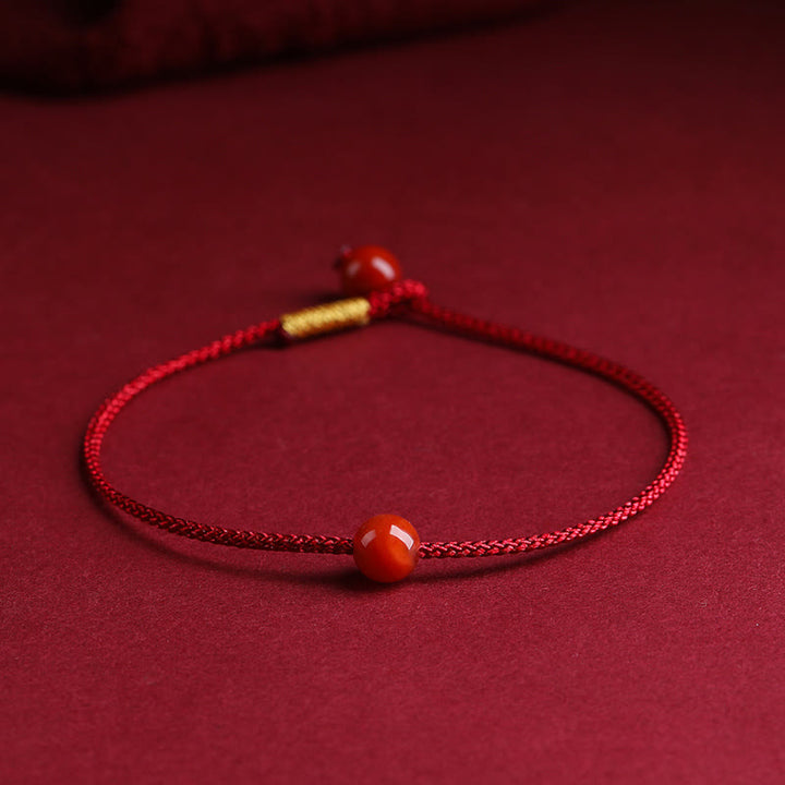Bracelet en fil rouge avec bénédiction en agate rouge cinabre naturelle de Buddha Stones