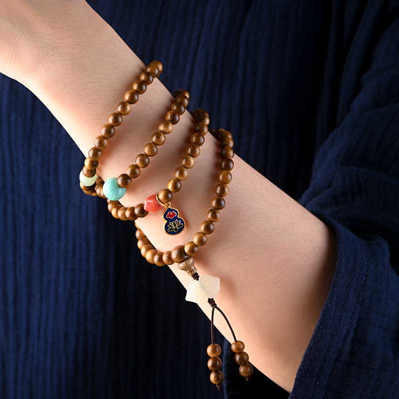 Bracelet Mala tibétain de protection et de calme en bois de rose avec Buddha Stones