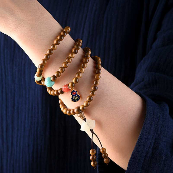 Bracelet Mala tibétain de protection et de calme en bois de rose avec Buddha Stones