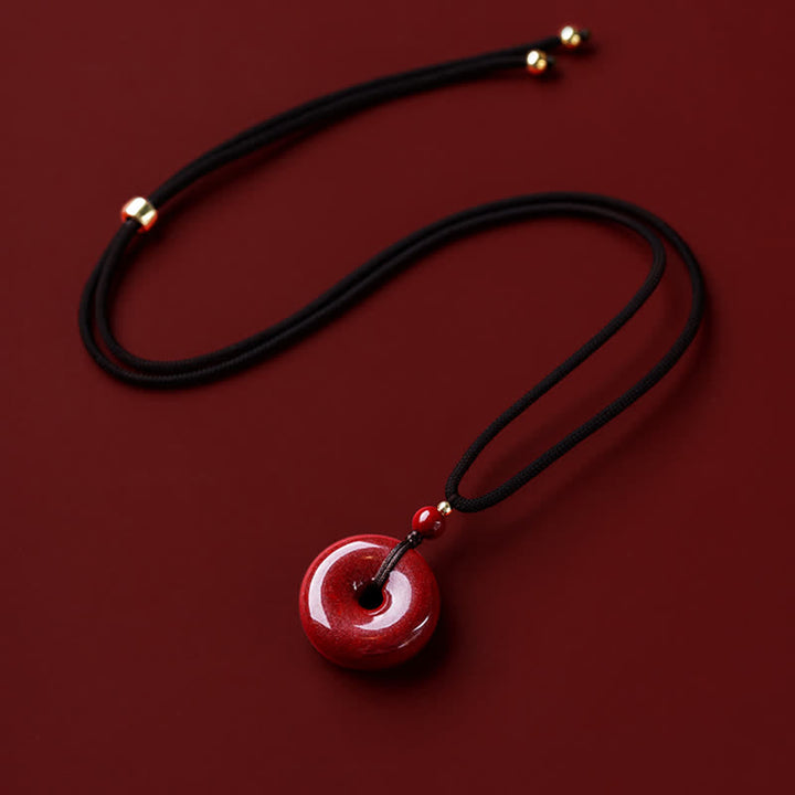 Collier avec pendentif en pierre de cinabre et boucle de paix en Buddha Stones