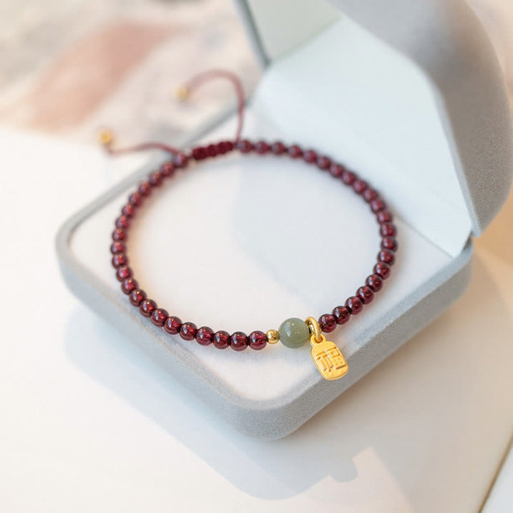 Bracelet porte-bonheur en Buddha Stones, quartz fraise, grenat, jade, caractère Fu