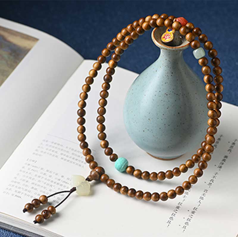 Bracelet Mala tibétain de protection et de calme en bois de rose avec Buddha Stones