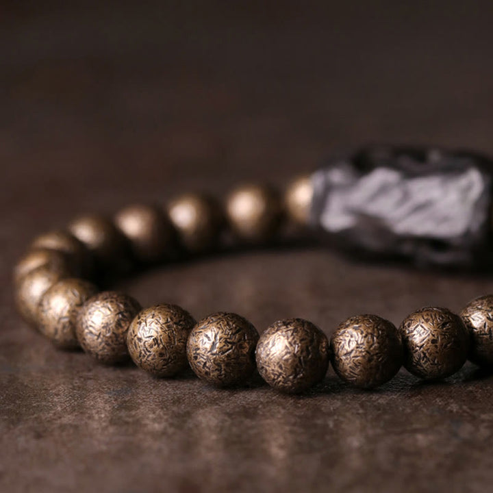 Bracelet de perles en bois d'ébène et cuivre avec Buddha Stones et équilibre