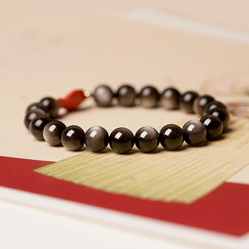 Bracelet de protection apaisante en obsidienne et cinabre avec Buddha Stones et reflets argentés naturels