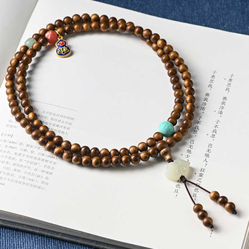 Bracelet Mala tibétain de protection et de calme en bois de rose avec Buddha Stones