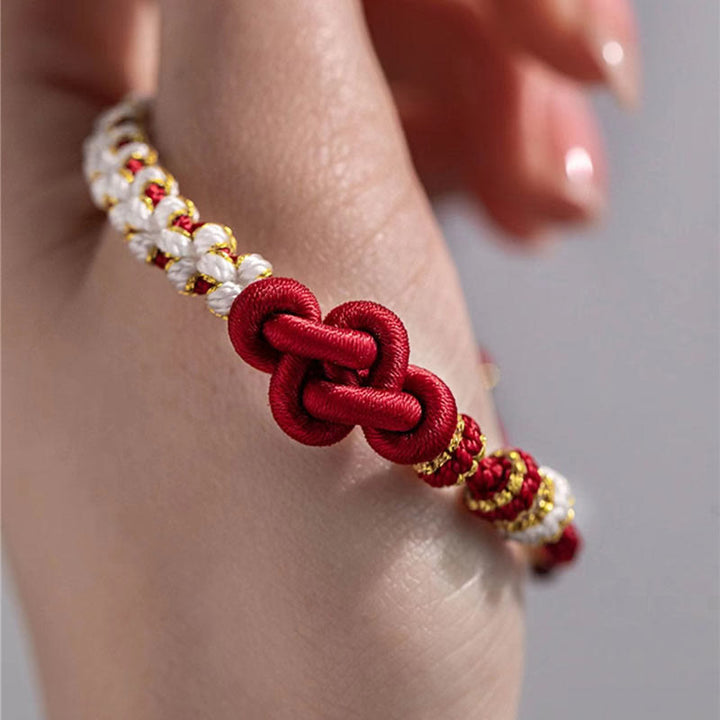 Bracelet porte-bonheur en corde avec breloque en fleur de pêcher et nœud d'amour véritable fait à la main par Buddha Stones
