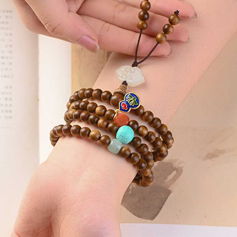 Bracelet Mala tibétain de protection et de calme en bois de rose avec Buddha Stones