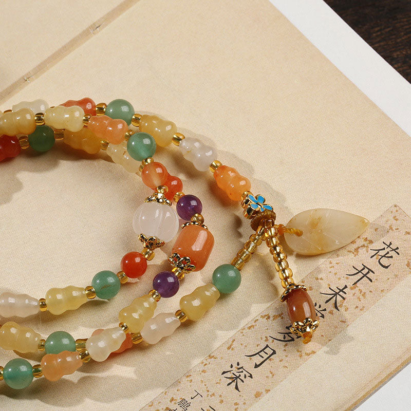 Bracelet de richesse en jade et soie dorée avec Buddha Stones