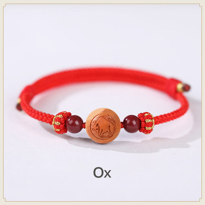 Bracelet de richesse en bois de pêche naturel Buddha Stones et caractère Fu du zodiaque chinois sculpté en cinabre