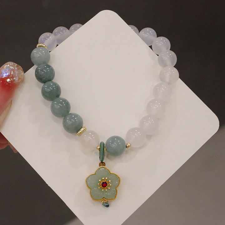 Bracelet de protection avec boucle de paix en Buddha Stones et jade blanc et fleur de lotus