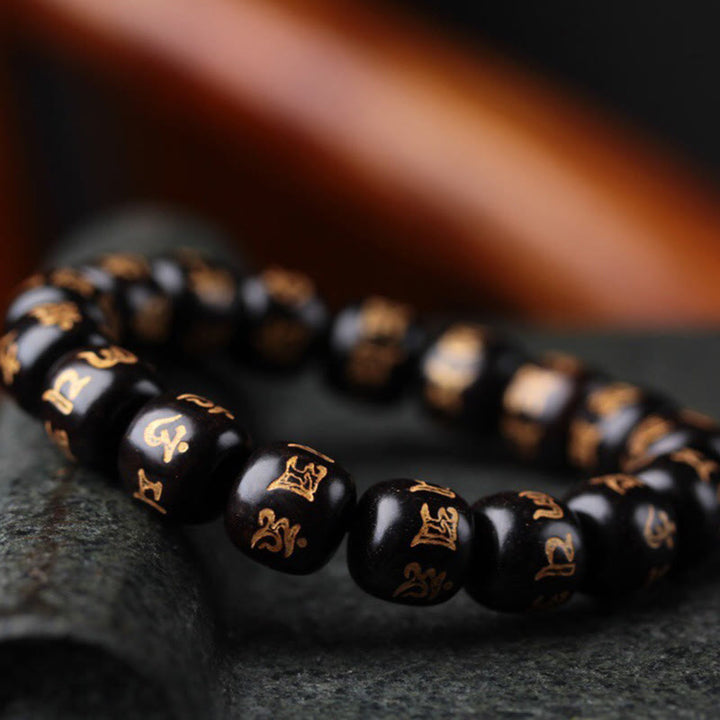 Bracelet de paix gravé en bois d'ébène tibétain avec Buddha Stones Om Mani Padme Hum