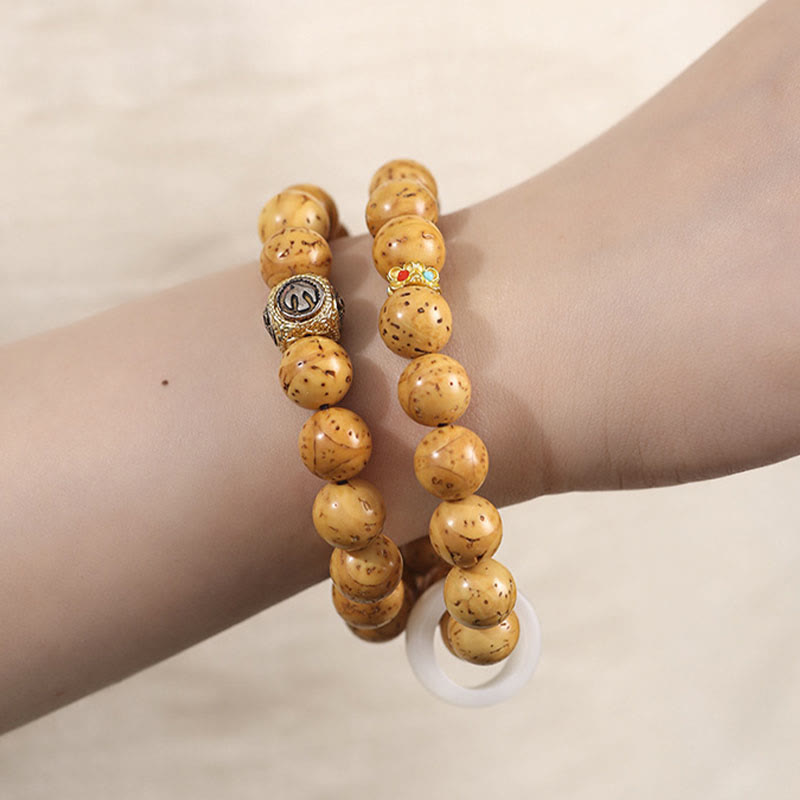 Bracelet double tour en Buddha Stones tibétaines naturelles violettes et dorées avec graines de Bodhi et de richesse