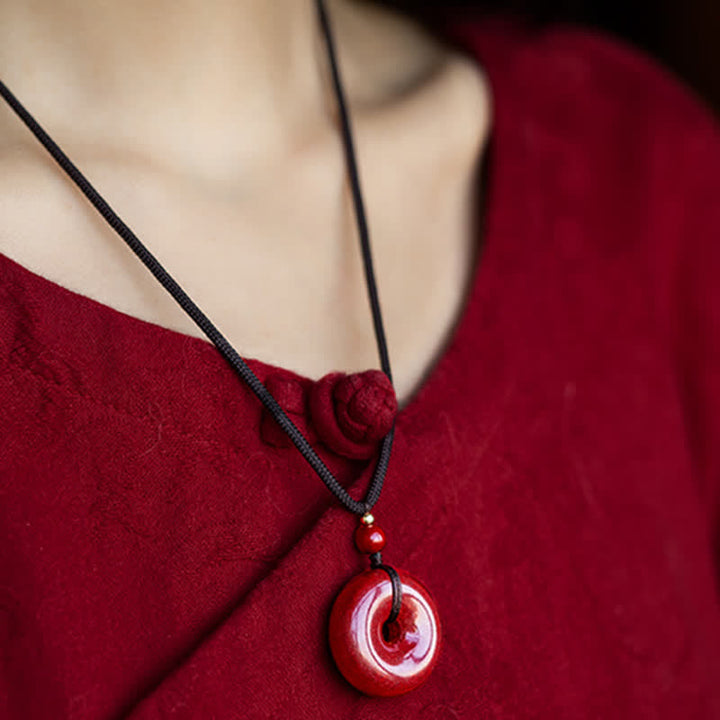 Collier avec pendentif en pierre de cinabre et boucle de paix en Buddha Stones