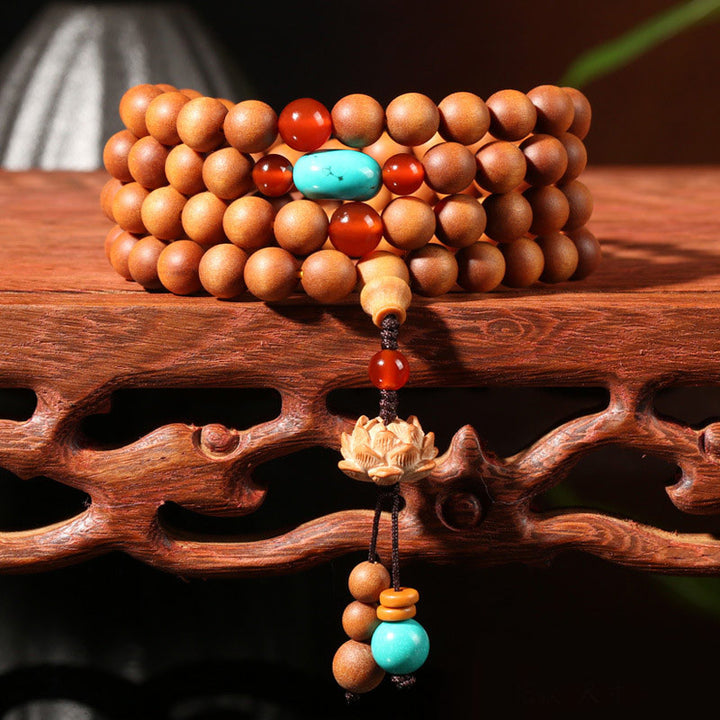 Bracelet Mala à breloques tibétaines en bois de santal et lotus avec Buddha Stones