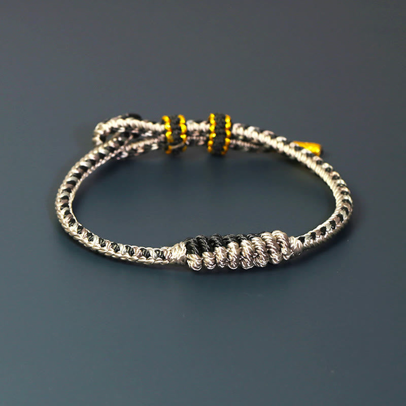 Bracelet de protection tressé à huit fils en Buddha Stones tibétain fait à la main avec roue de prière et nœud de paix