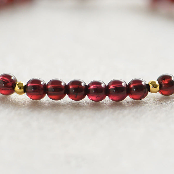 Bracelet de stabilité en perles dorées et grenat naturel avec Buddha Stones