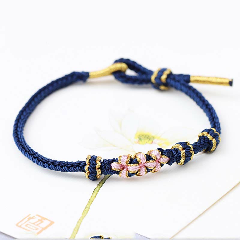 Bracelet tressé fait main à huit brins avec trois fleurs de pêcher et Buddha Stones