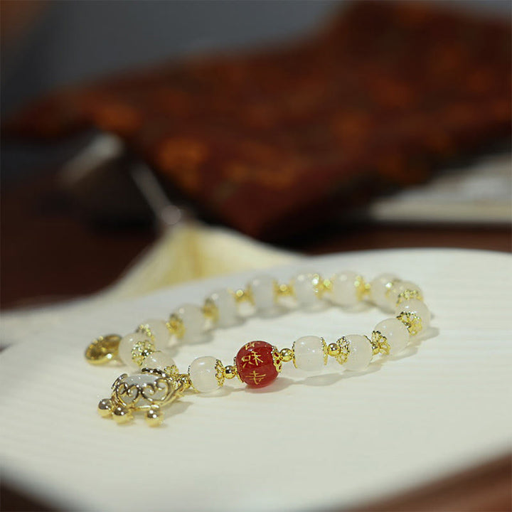 Bracelet de bénédiction avec breloque en forme de moulin à vent en Buddha Stones et caractère Fu