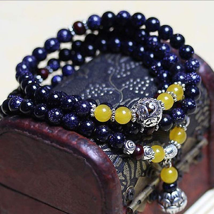 Bracelet Mala en grès bleu avec breloques de richesse et Buddha Stones