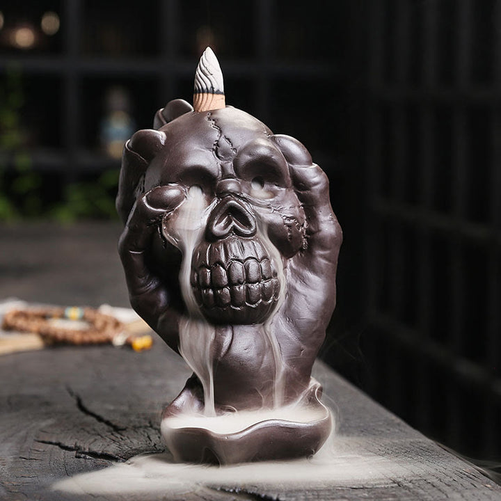 Brûleur d'encens spirituel en argile violette avec tête de mort et main fantôme en Buddha Stones