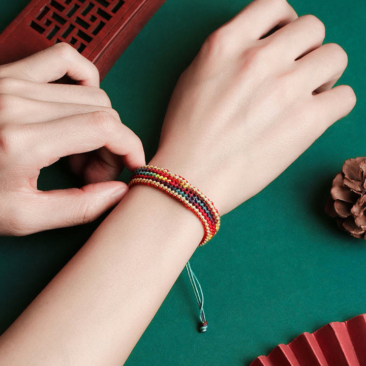 Bracelet tressé de protection multicolore arc-en-ciel fait main en Buddha Stones tibétaines