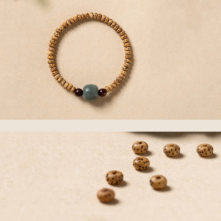 Bracelet de sagesse en bois de santal rouge à petites feuilles et Buddha Stones