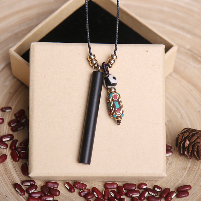 Collier pendentif en perles dzi en bois d'ébène tibétain avec symbole de paix et de calme - 5,5 x 0,6 cm - image 0