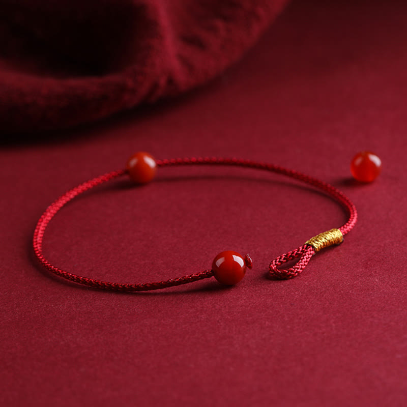 Bracelet en fil rouge avec bénédiction en agate rouge cinabre naturelle de Buddha Stones
