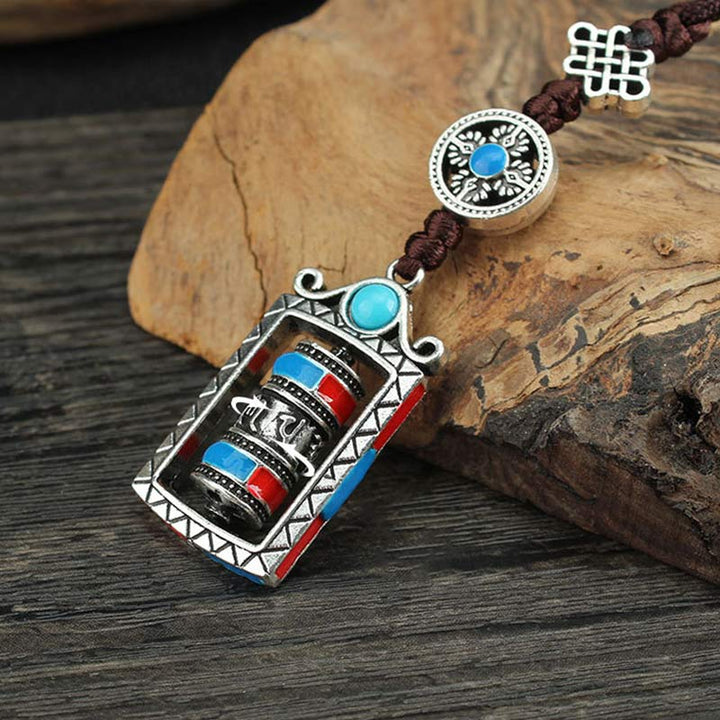 Porte-clés décoratif avec nœud rotatif et bénédiction en forme de roue de prière en six mots vrais en Buddha Stones