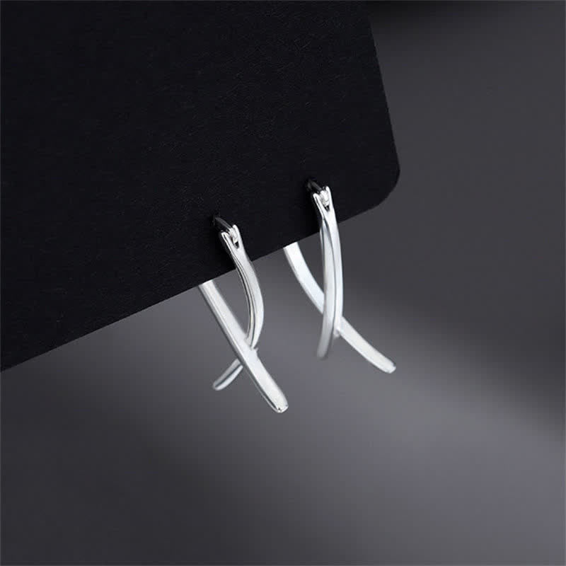 Boucles d'oreilles créoles porte-bonheur à motif géométrique croisé