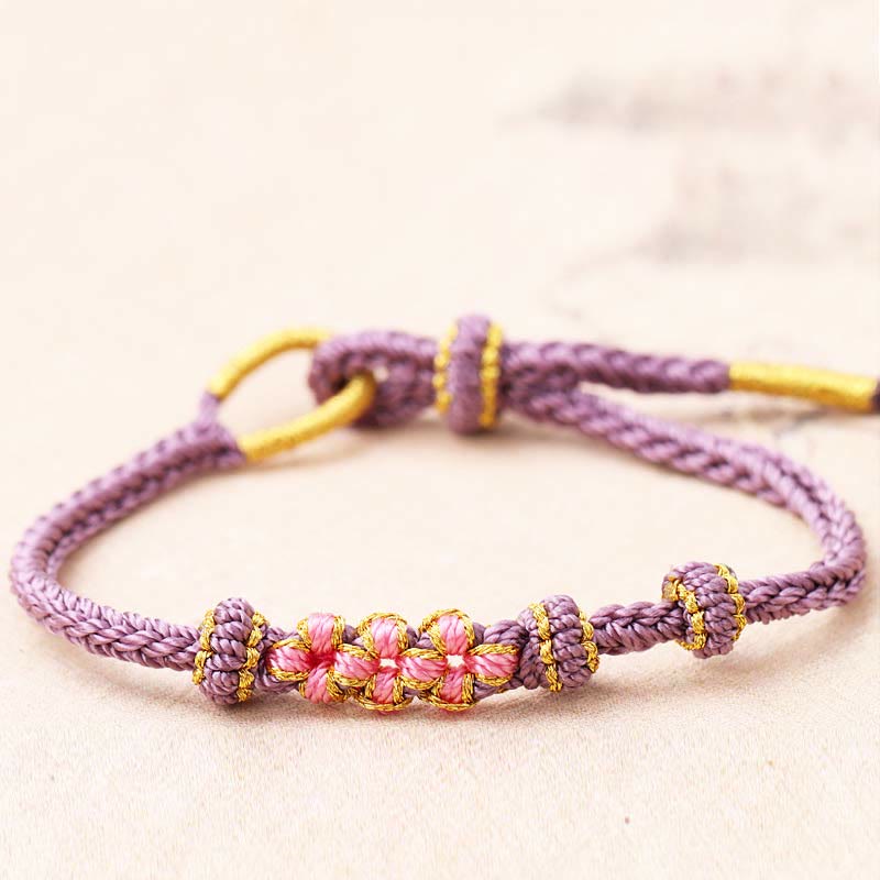 Bracelet tressé fait main à huit brins avec trois fleurs de pêcher et Buddha Stones