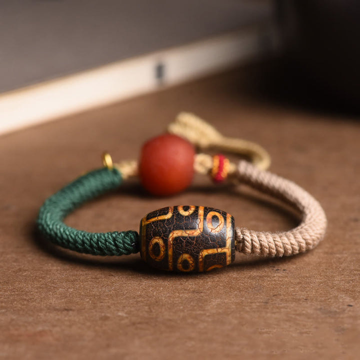 Bracelet en corde de richesse en perles tibétaines à neuf yeux Dzi fait main par Buddha Stones